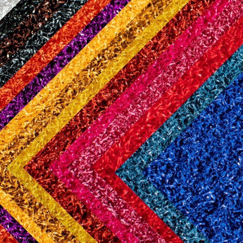 Vibrant multi-color artificial turf surface samples featuring custom synthetic grass options in various bold shades and textures”