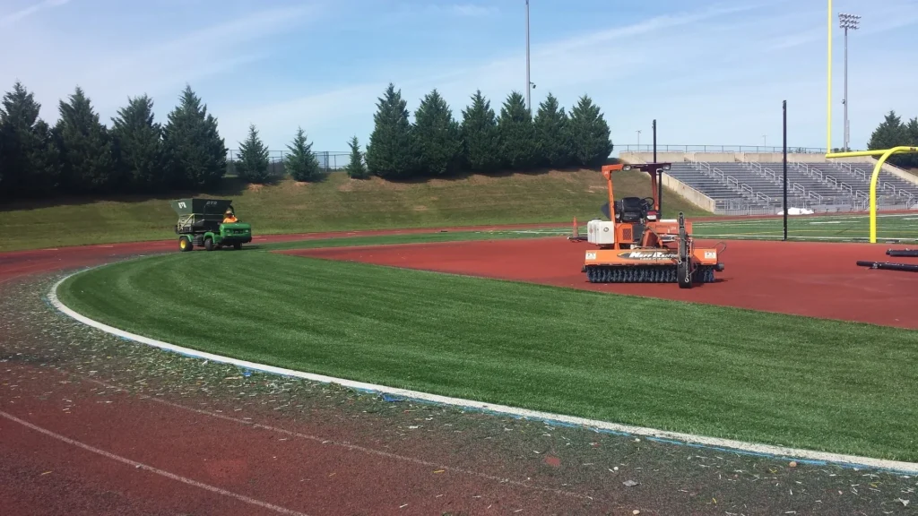 GTR Turf maintenance equipment grooming synthetic athletic field and track surface for professional sports field upkeep