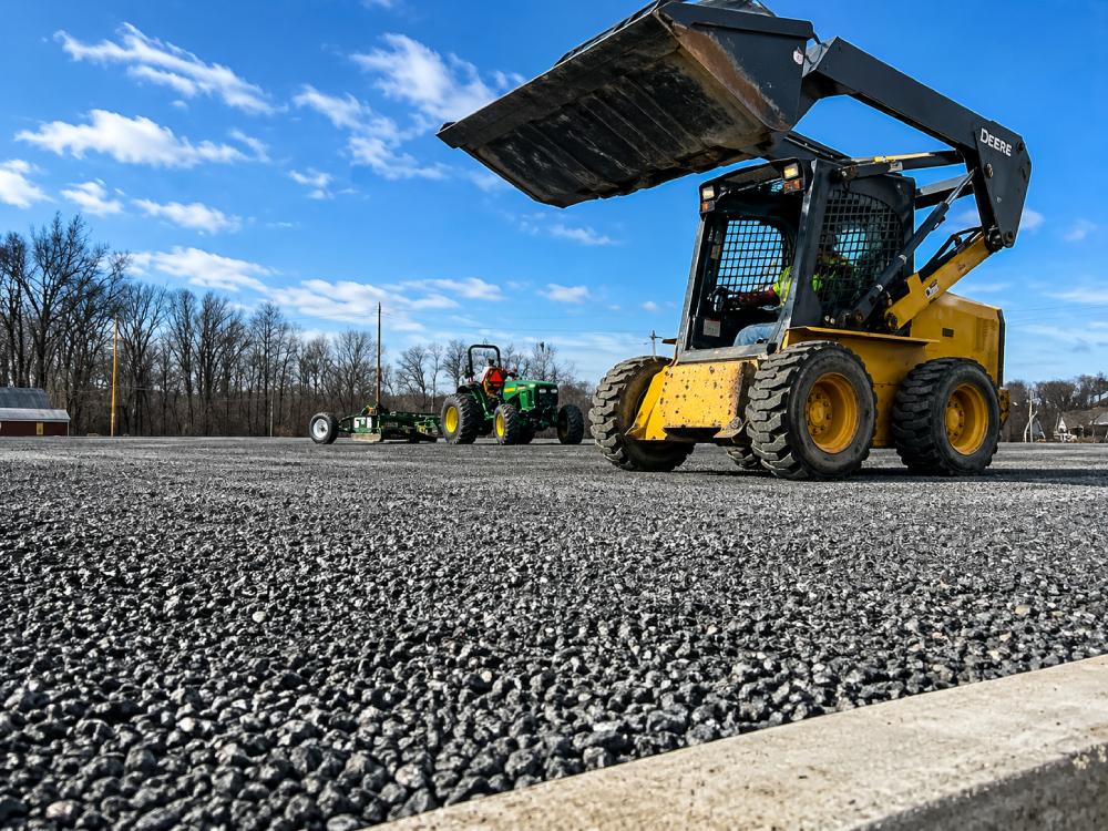 Heavy equipment preparing aggregate base foundation for GTR Turf synthetic sports field installation.